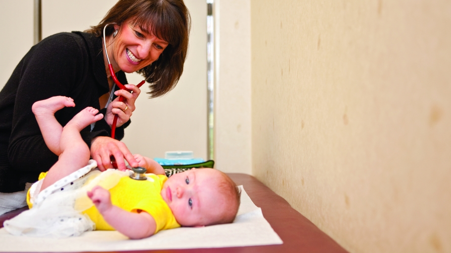 pediatrician examining a baby